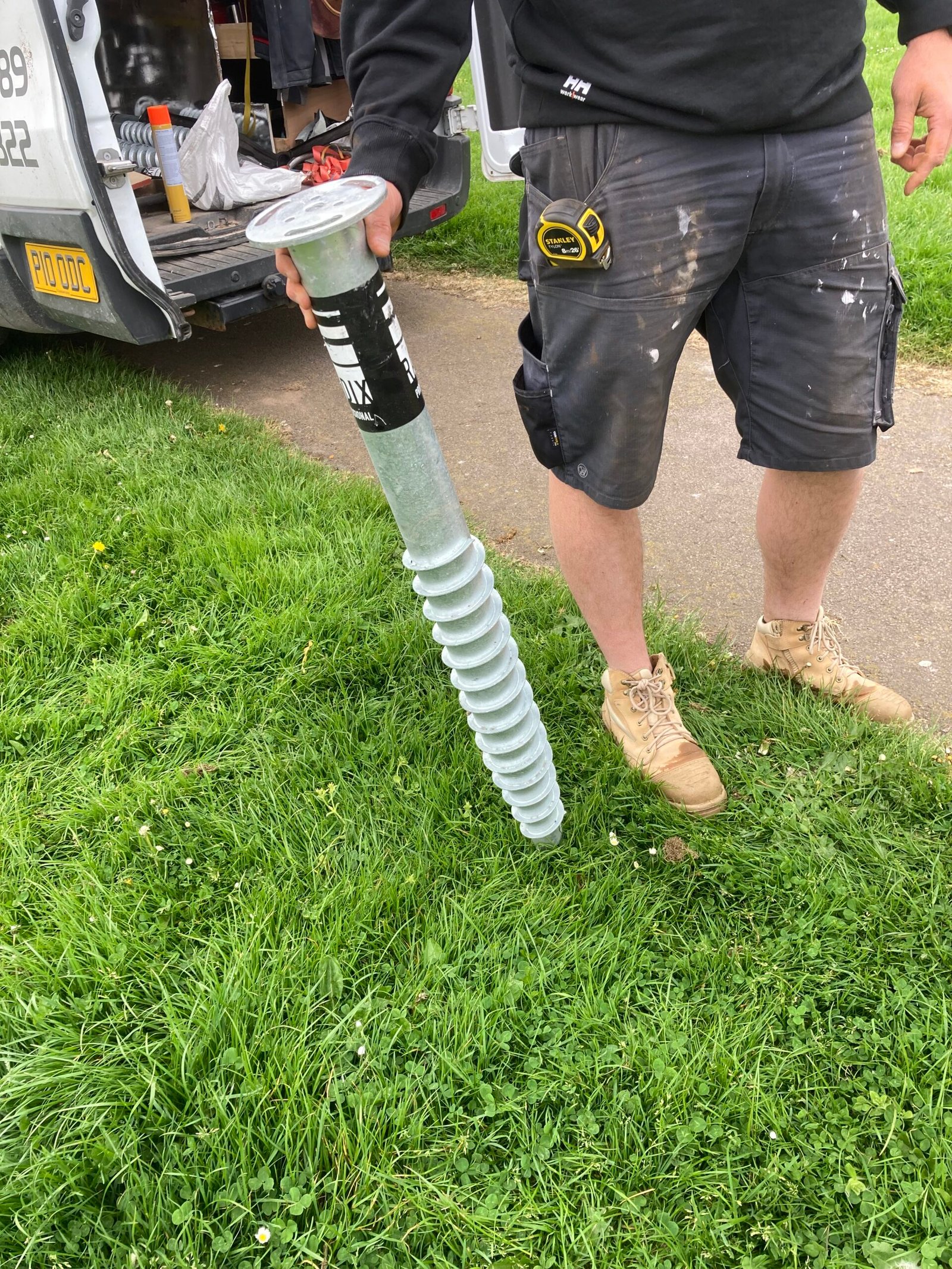 Ground Screw being presented, reaches Greg's waist.